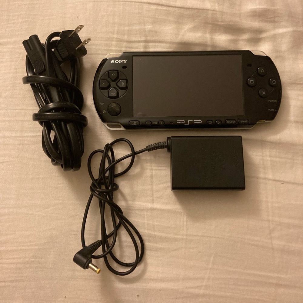 Sony PlayStation PSP 3001 circa 2011 with charger and memory card